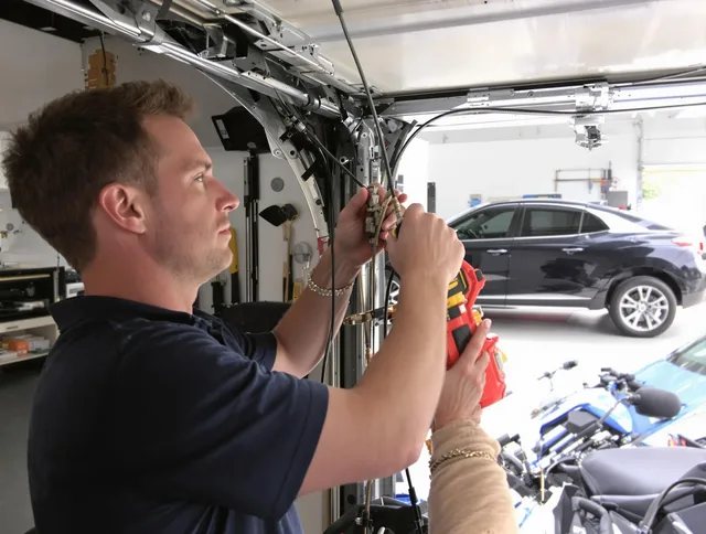 Pomona Garage Door Repair safety certified technician performing cable replacement in Pomona